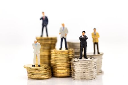 Miniature people : Businessman standing on stack of coin. Image use for financial, business vision concept.の写真素材