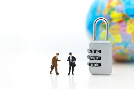 Miniature people:  Businessman looking for password of security key. Image use for background security system, hack, business concept.の写真素材