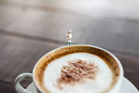 Miniature people : Coffee cup with barista, image use for charge your energy in the morningの写真素材