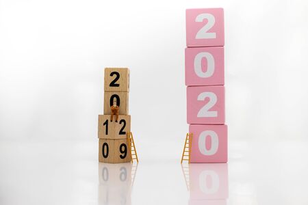 Miniature people : Starting from the old year to the new year, Image use for the new beginning of life, business conceptの写真素材