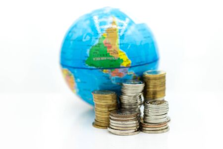 Stack of coin beside the world map. Image use for investment, business international concept.の写真素材