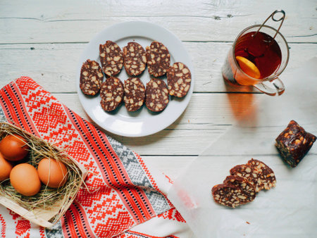 cup of tea with lemon, chocolate pudding, eggs, cake on the tableの写真素材