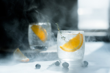 Glass of water that looks cool and refreshing. And orange slices in the glassの写真素材
