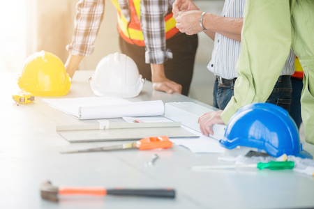 Team engineers and foreman discuss in construction siteの写真素材