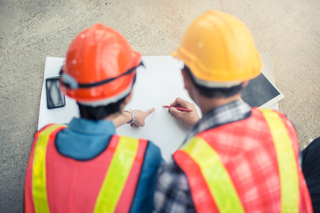 Engineer or Architect working at Construction Site with white paper, Focus on the paperの写真素材