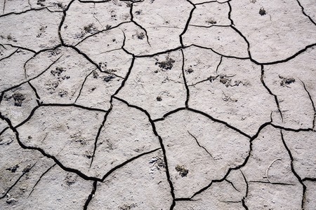 Texture cracked earth in day time. Extreme terrain background