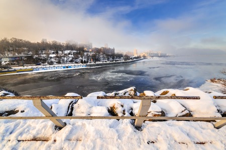 Beautiful view of the city at sunrise of early foggy sunny morning. Monastyrsky Island, Dnepropetrovsk, Ukraineの写真素材