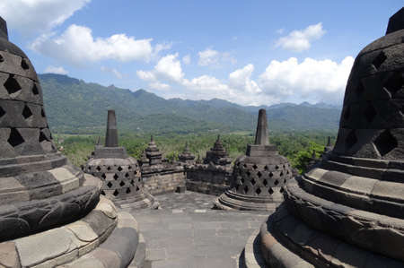 Borobudur Temple Indonesia clear blue sky with hills in the distanceの写真素材