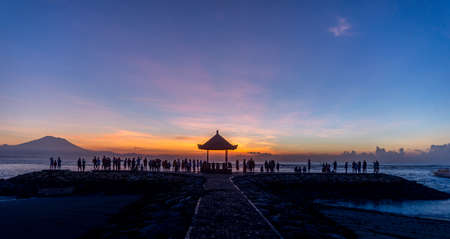 People relaxing watching a sunrise in Sanur Baliの写真素材