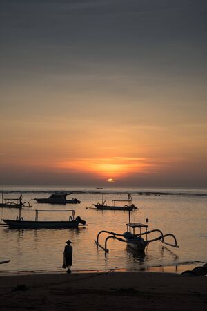 Man contemplsting fishing with a net in Baliの写真素材