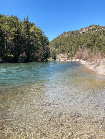 The strong stream of the mountain river comes down from the mountains crystal clear and icyの写真素材