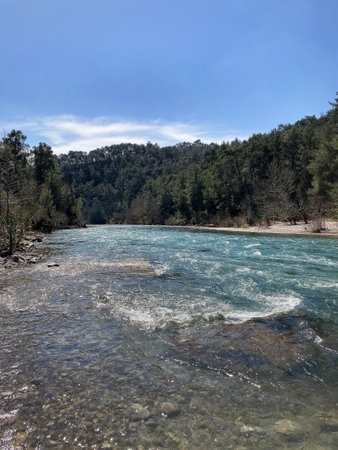 The strong stream of the mountain river comes down from the mountains crystal clear and icyの写真素材