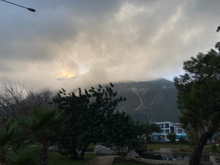 Low fluffy clouds hang over the high mountains, cover their peaksの写真素材