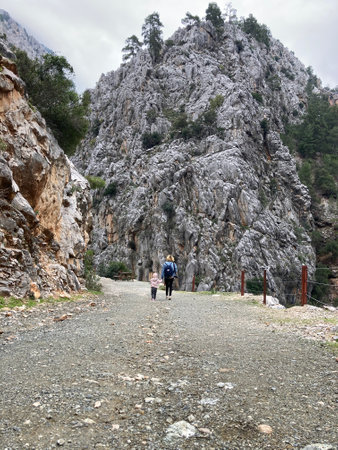 People walk along the gorge along the high cliffs of Turkey goynuk canyonの写真素材