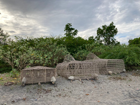 Trap for crab fish lobster lobsters cages braided from bamboo lie on a sandy shoreの写真素材