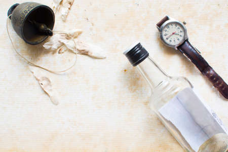 An vintage image of collection of items while traveling. They are including watch, rice whisky and bellの写真素材
