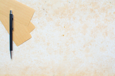 Paper note and pen on grunge cavasの写真素材