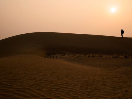 Silhouette photographer at Thar Desert in sunset time Jaisalmer Rajasthan State Indiaの写真素材