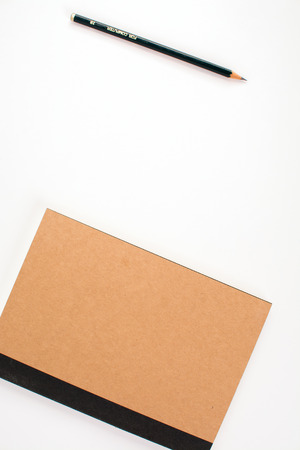 Wood pencil and notebook on white backgroundの写真素材