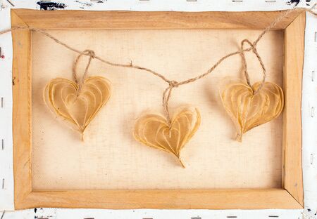 Paper hearts on the canvas frame with packthread vintage image