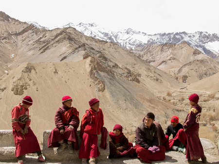 Ladakh, India - April 08, 2012 : Little Ladakhi Monks make themselves warm under sunshine.の写真素材