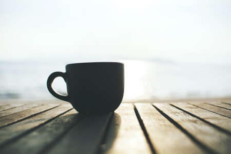 Cup of coffee on wood table in the morningの写真素材