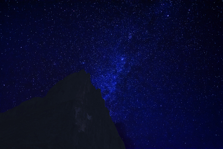 Mountain peak in the dark night with starsdust backgroundの写真素材