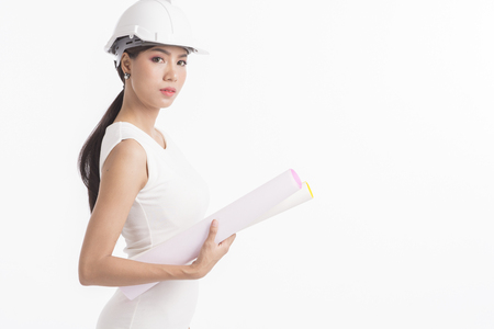 Sexy girl structural engineer holding drafting paper with copy space for product or text, white background photoの写真素材