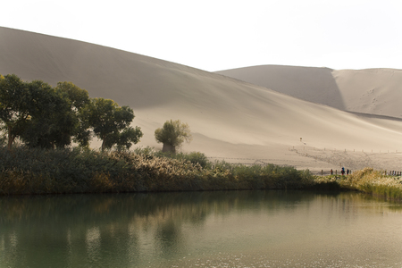 Lake and sand dune in desert at Dunhuang city, Gansu Province, Chinaの写真素材