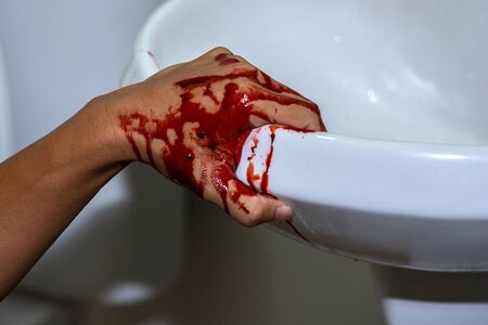 Injured hand with blood on basinの写真素材