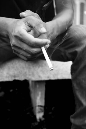 Man smoking cigarette, black and white photographyの写真素材