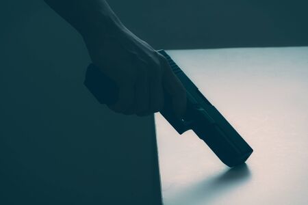 Hand of man with gun, monotone imageの写真素材