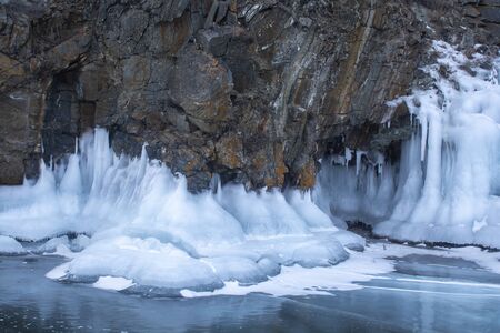 Rock cliff with ice stalactite in Lake Baikal, Russia, landscape photographyの写真素材