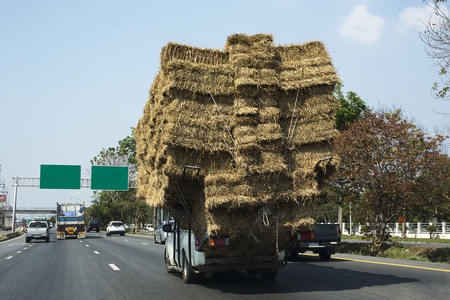 Rice straw, Overloaded truck on road in Saraburi Province, Thailand/ March 2018のeditorial素材