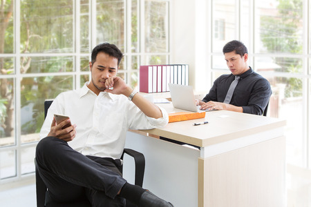 Businessmen think about jobs. Businessman are sitting thinking something on the table. Asian men thinks about a problem.の写真素材
