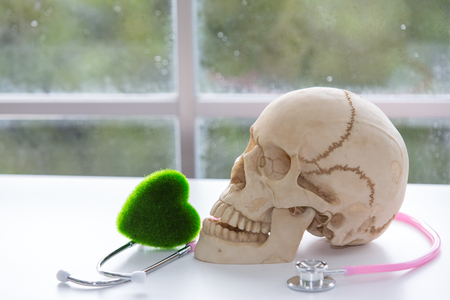 Substance Abuse Harmful. Drug addiction. Skull and stethoscope. stethoscope and green heart. Scientists experiment with drugs.の写真素材