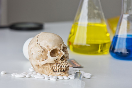 Science laboratory test tubes. Skull and beaker chemical. Volatile substances and skull laboratory. glassware with liquids of different colors.の写真素材