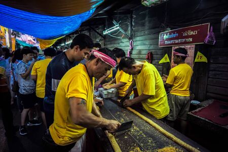 Candy shop merchants are making cakes. With a mixture of nuts and sugar in vegan/vegetarian festival in Thailand, Talad Noi, Yaowarat or Bangkok China town, Bangkok, Thailand. 13 October 2018.のeditorial素材