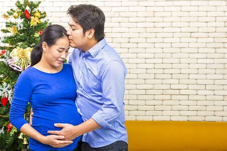 Father kiss Pregnant mother. Young future parent happy together. Father and mother enjoying. Mom and...