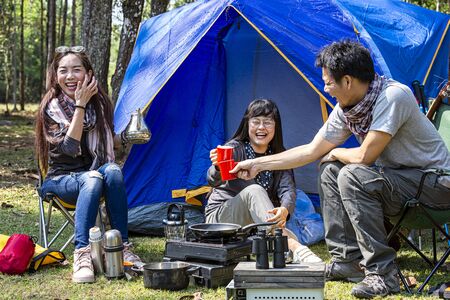 Tourists are camping in the forest. Group of adventure tourist camping enjoy and happy in coffee...
