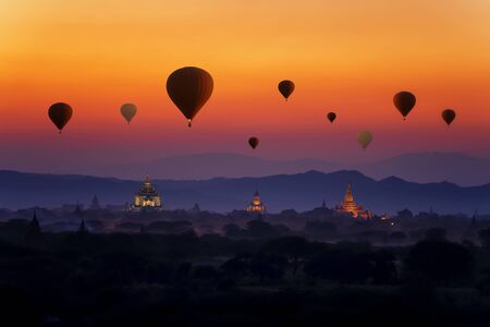 Sunset many hot air balloon with stupas in Bagan, Myanmar. Bagan is an ancient with many pagoda of...