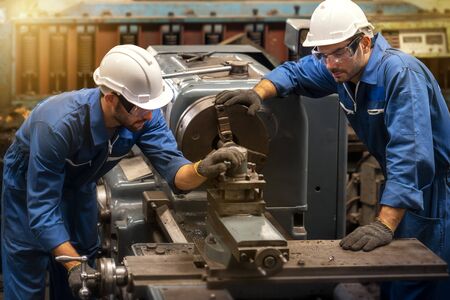 Technicians and engineers are working on machines in a factory. Twins Caucasian man Mechanical Engineer checking equipment in the industrial.の写真素材