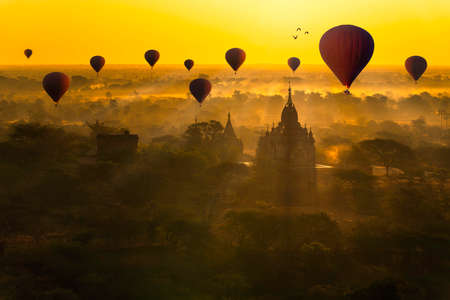 Sunrise many hot air balloon in Bagan, Myanmar. Bagan is an ancient with many pagoda of historic buddhist temples and stupas.の写真素材