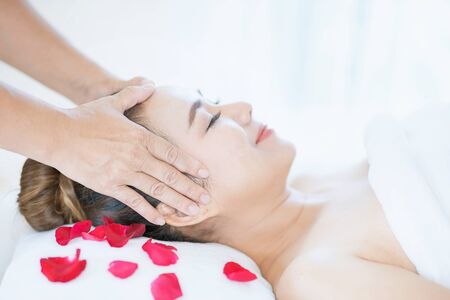 Hand on head. Facial Massage, Spa Massage, Relaxing facial massage at spa salon. Happy young beautiful woman enjoying head massage at the spa beauty clinic.の写真素材