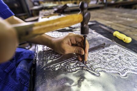 Silverware making. Thai craftman are making silverware. The original of the silver craftsmen on Wua Lai road, Chiang Mai. Thailand.の写真素材