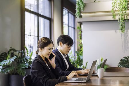 Co-working space concept. Young staff are consulting with beautiful female employees. Company...