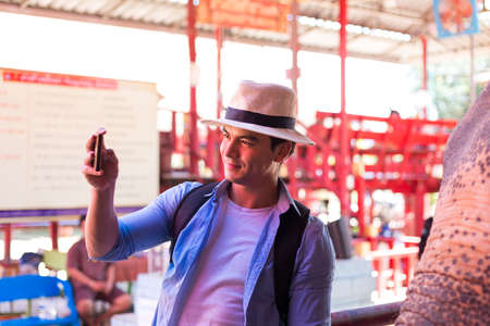 Tourists is shooting self portrait.