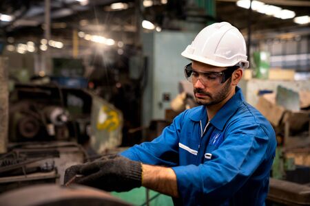 Engineers and technicians Holding a tablet computer In the factory. Technicians and engineers are working of machinery in industrial plants.の写真素材