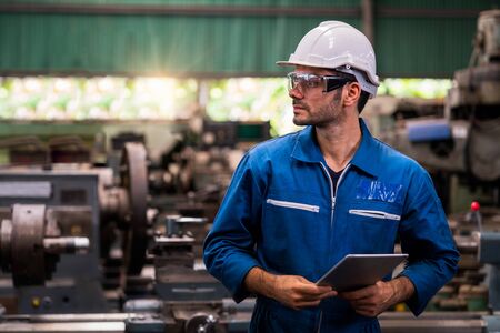 Engineers and skilled technicians are maintaining machinery. Professional technicians are holding a...