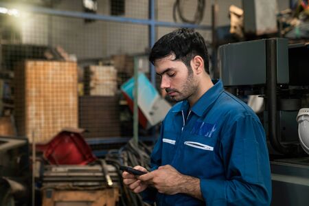 Professional technicians are resting and using mobile phones.の写真素材